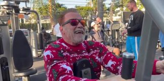 Arnold Schwarzenegger in holiday sweater as he exercises on Christmas Eve: ‘We’re still working out’